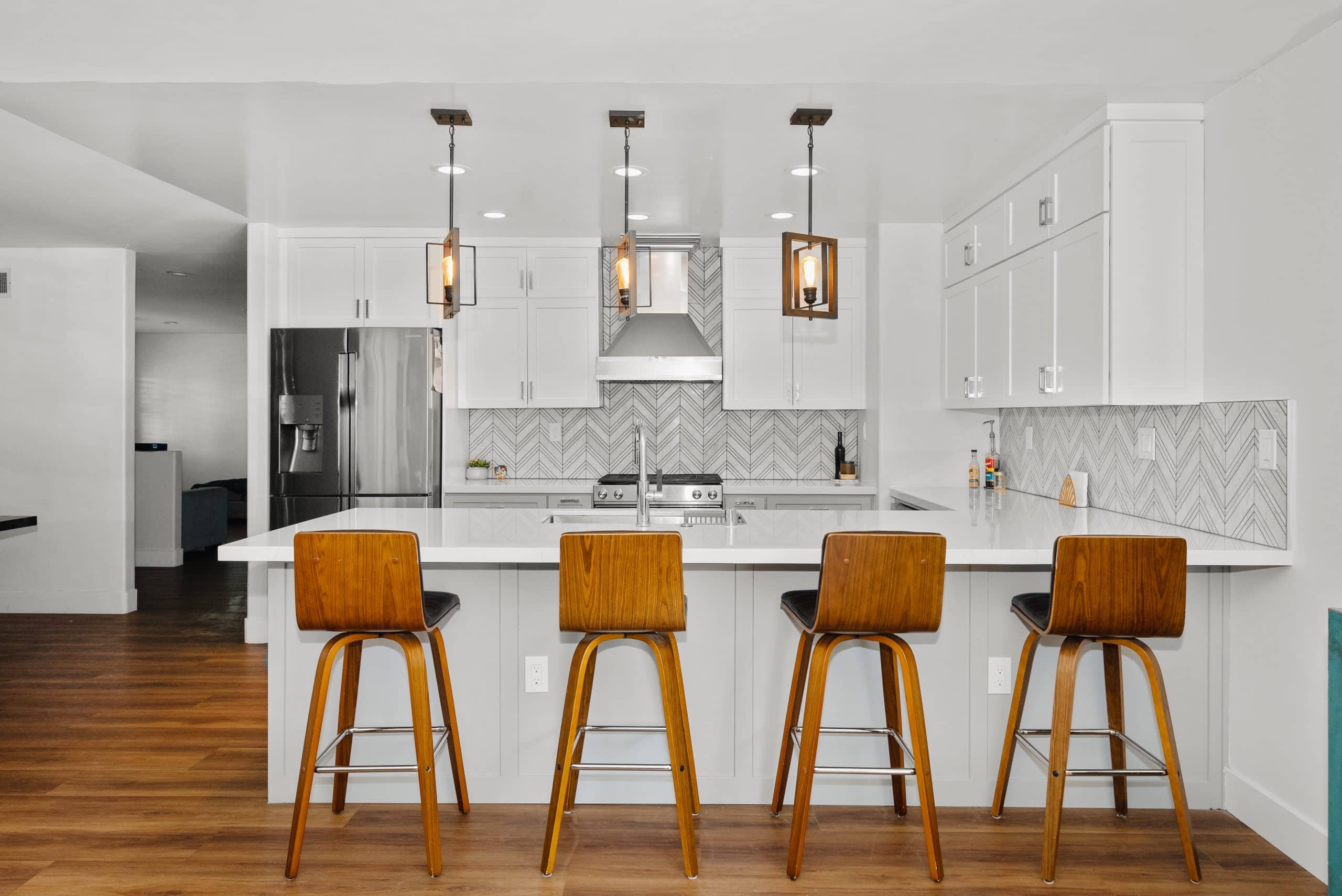 Discovery Bay remodel — white kitchen with waterfall island and bar stools