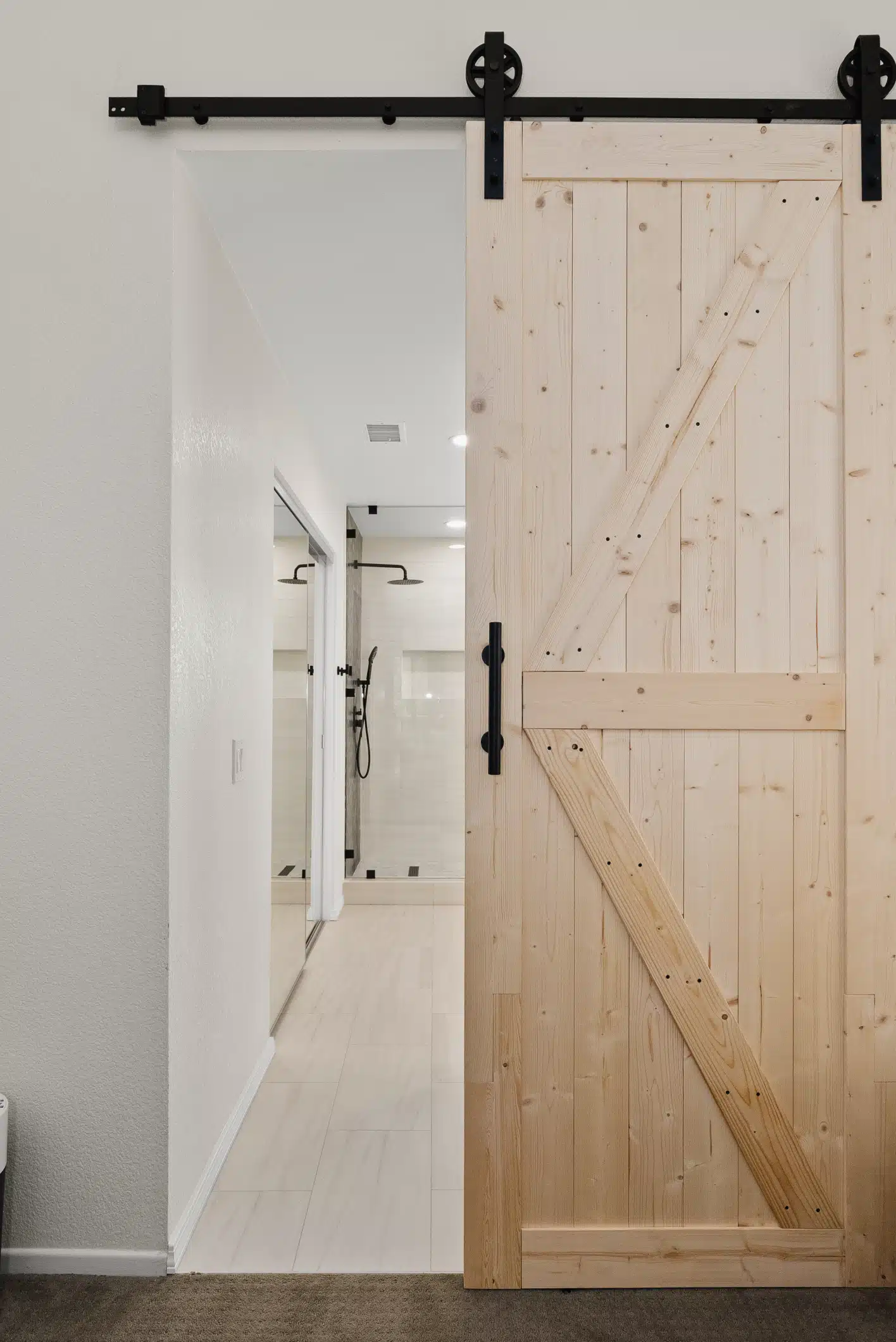 Moraga bathroom — custom wood sliding barn door at the entry