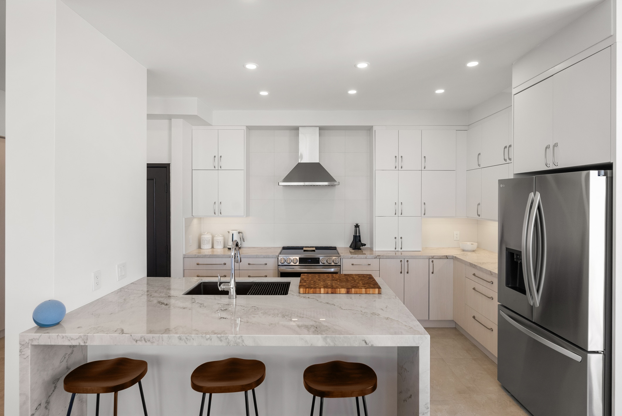 Lafayette kitchen remodel — marble waterfall island and pale-oak cabinetry