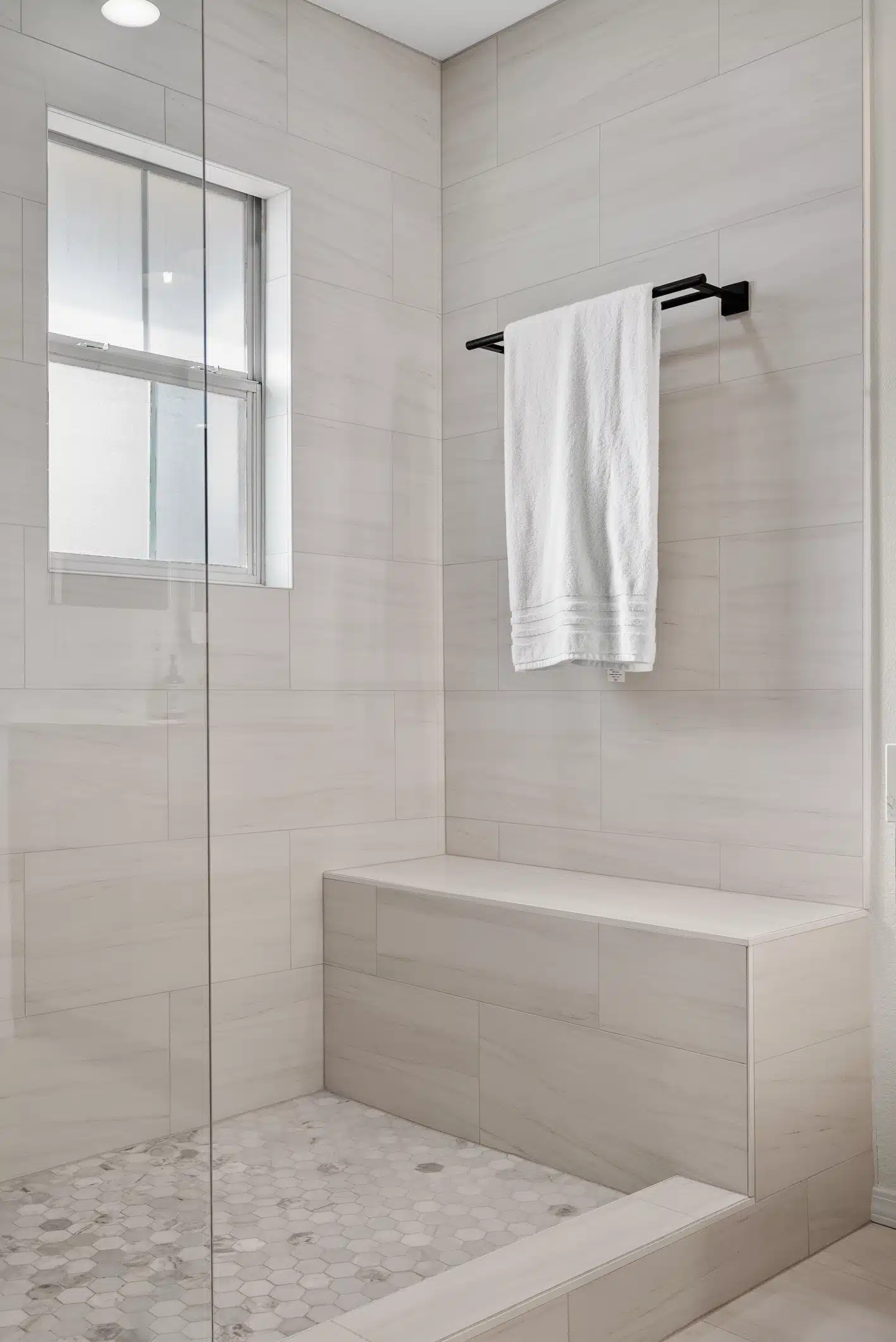 Moraga primary bath — tiled shower bench, niche and mosaic floor