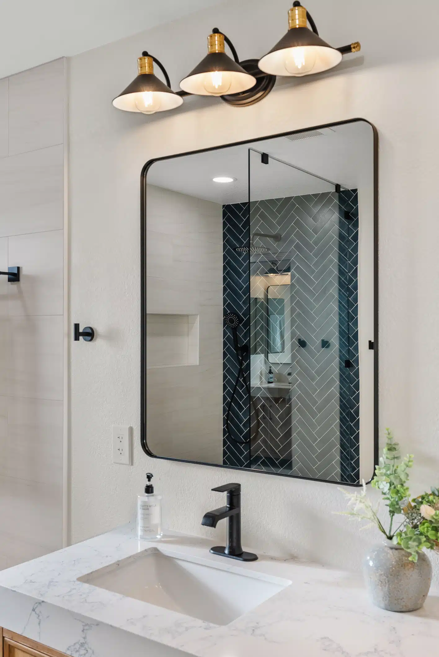 Moraga bathroom — vanity, mirror and reflected herringbone feature wall