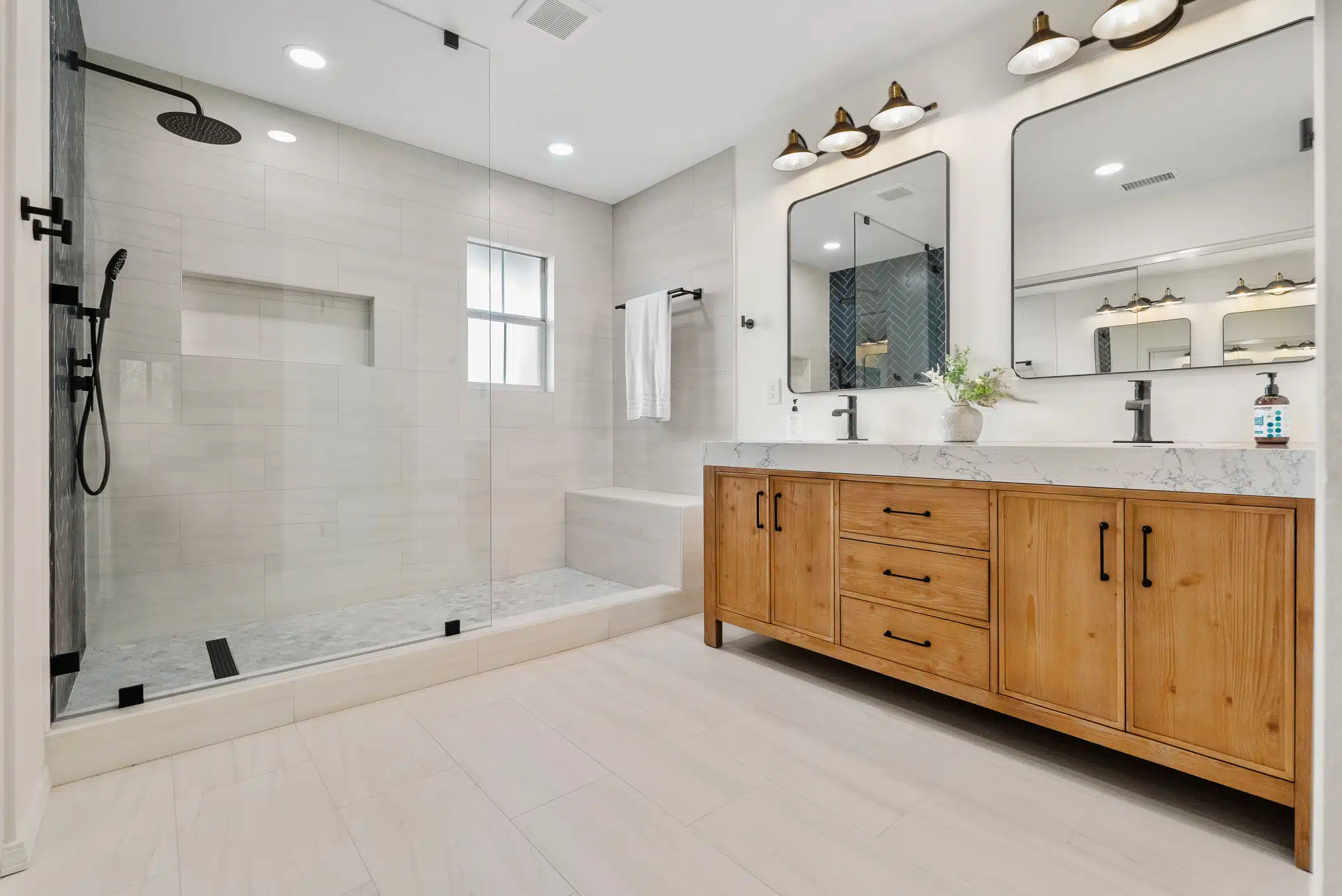 Bathroom remodel in Moraga, CA — primary bathroom with walk-in shower and double wood vanity by Rhino Builders