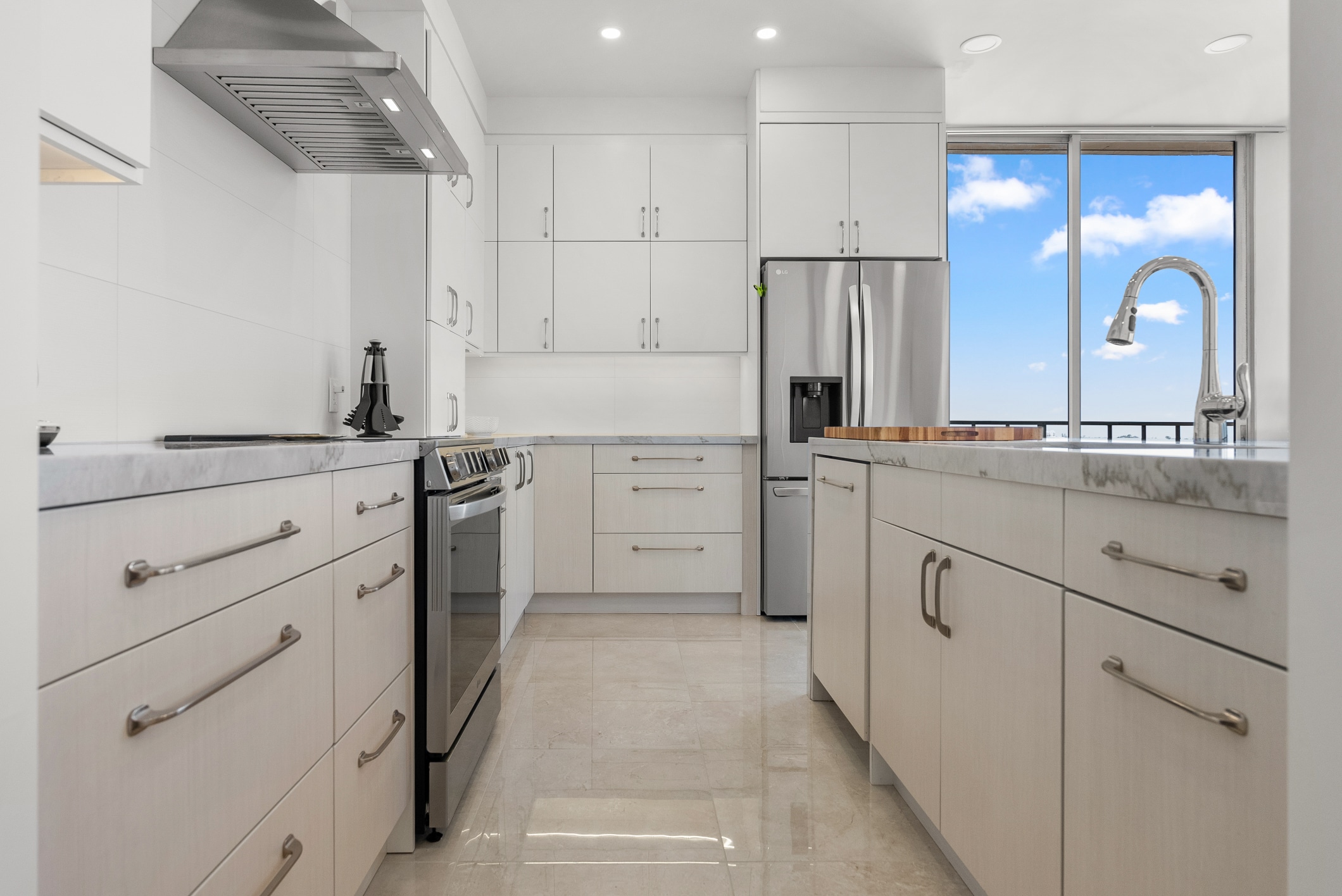 Lafayette kitchen remodel — galley layout with marble counters and city view