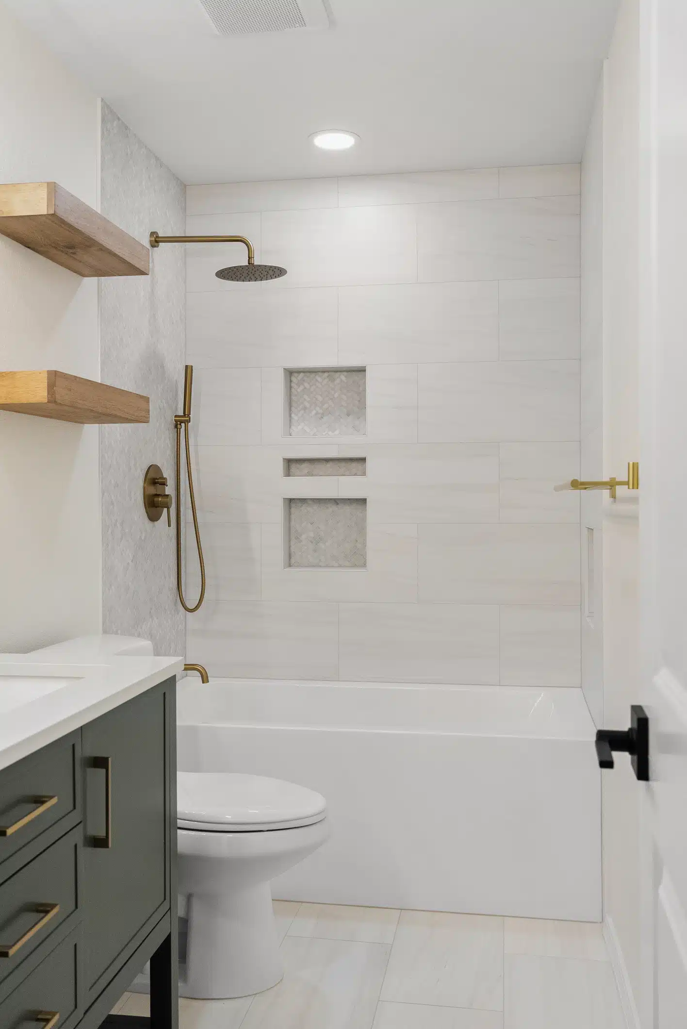 Moraga guest bathroom remodel — green vanity, brass fixtures and tub-shower