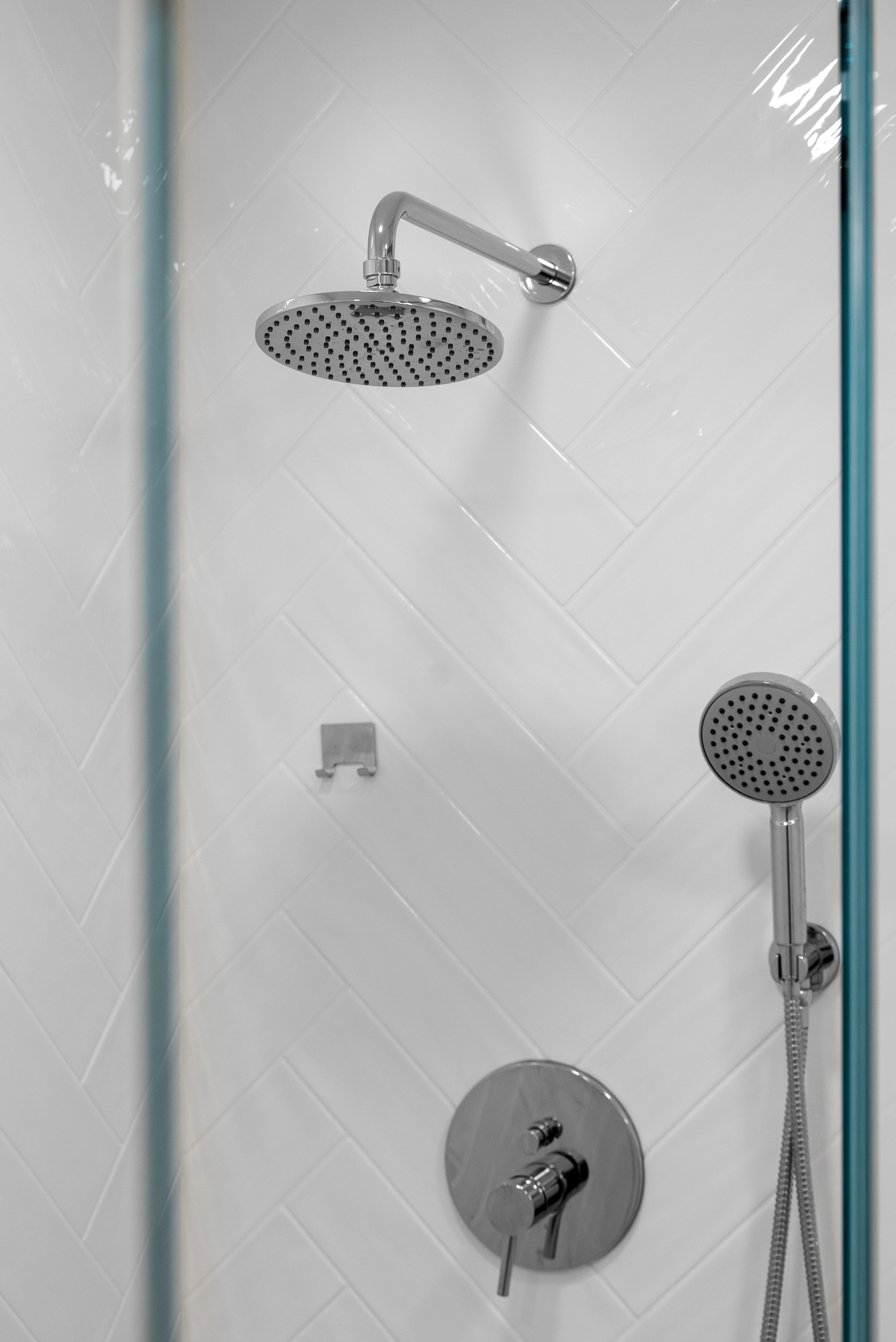 Lafayette bathroom remodel — white herringbone shower with polished fixtures