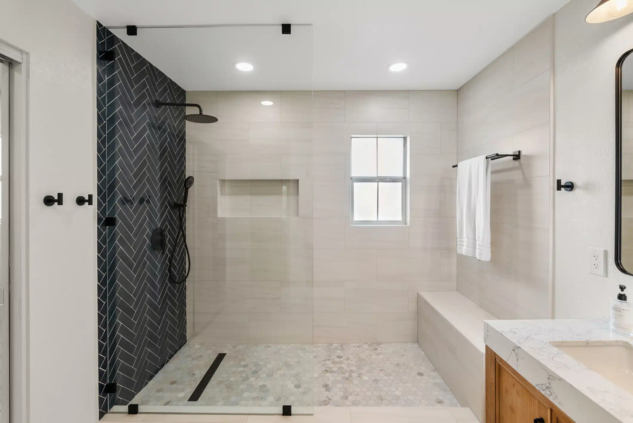 Moraga primary bathroom — curbless shower with bench and private window
