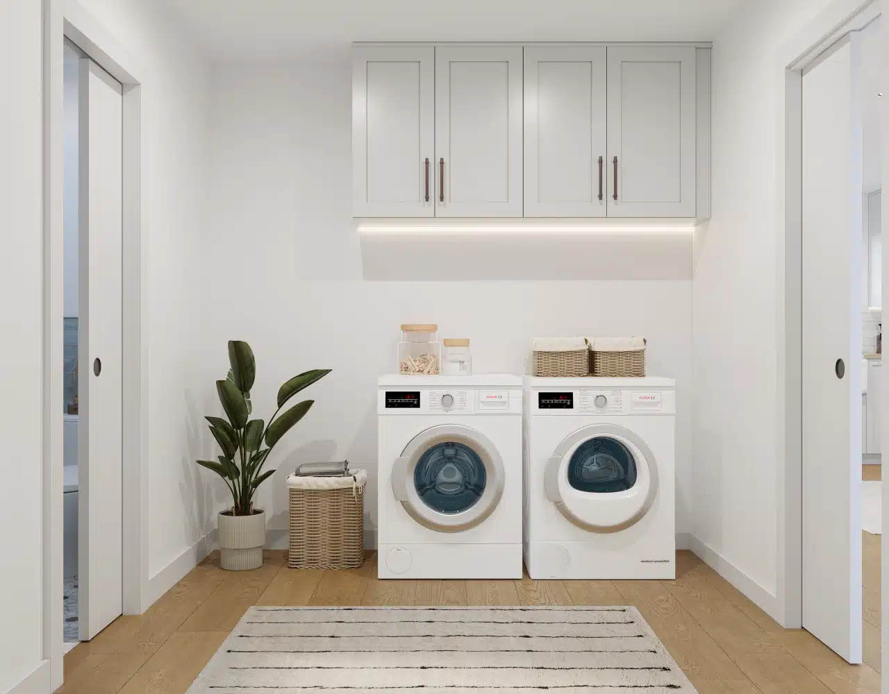 Fremont laundry room remodel — upper cabinetry with under-cabinet lighting and washer-dryer