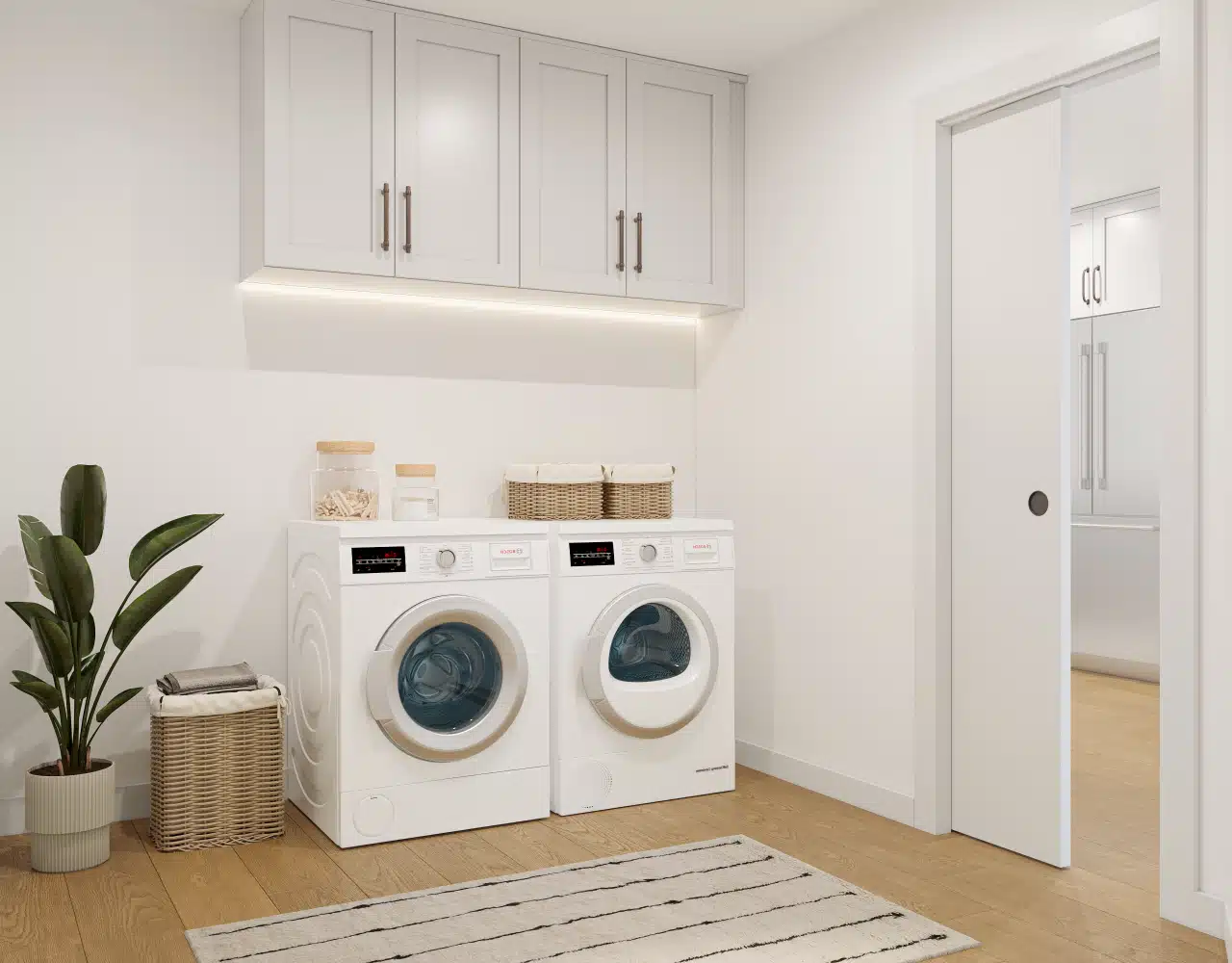 Fremont laundry room — custom cabinetry, wood floors and side-by-side machines