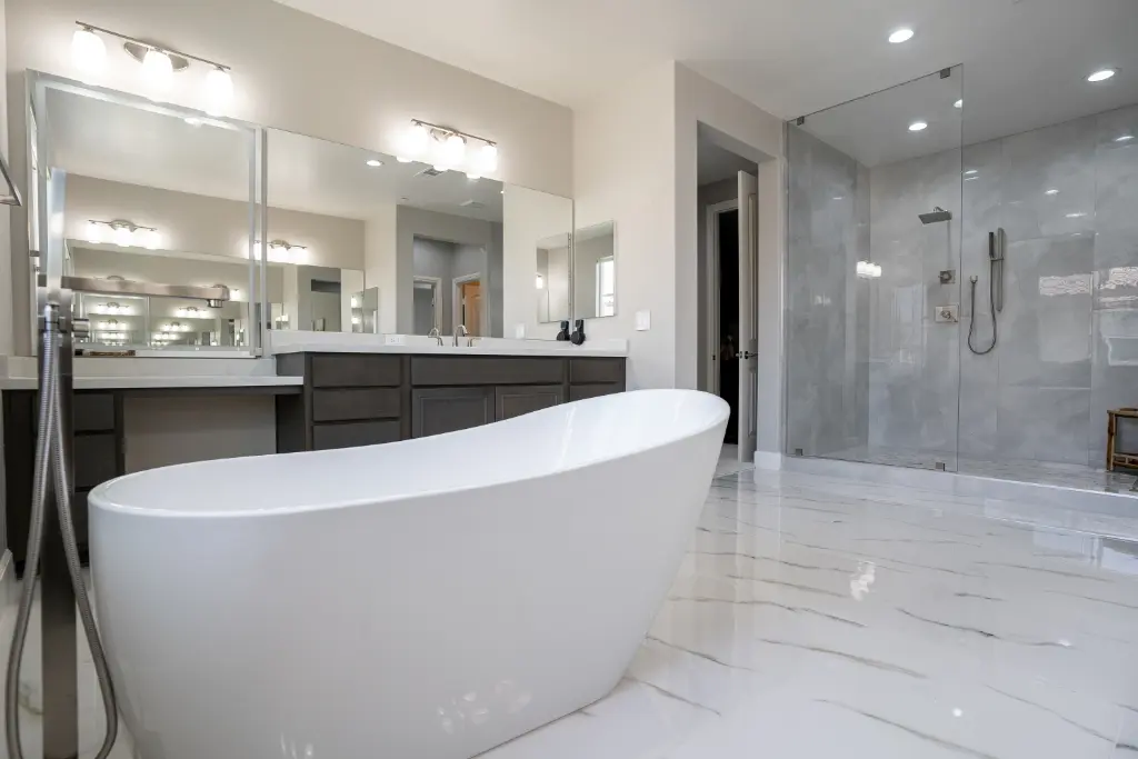 Modern bathroom with freestanding white bathtub, double vanity mirrors, and glass-enclosed walk-in shower