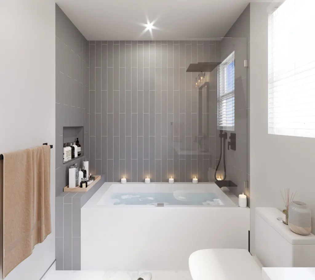 Modern bathroom with a built-in soaking tub, gray tiled walls, glass shower panel, and candles along the tub edge